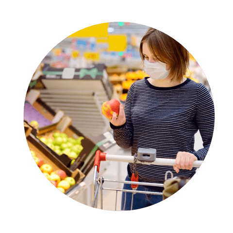 Image of shopper browsing fruit section at the supermarket